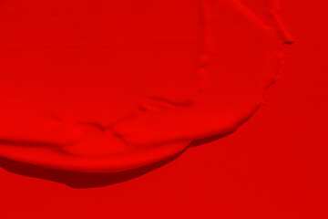 Beautiful texture of a rich, bright red color. Scarlet color. Texture of lipstick, eyeshadow,...