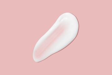 A dab of cosmetic cream. Light, smooth surface. Texture of spreadable cream. Liquid cream smear. On a pink background.
