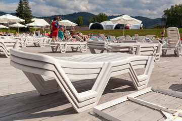 Stack of sun loungers on the beach. Preparing the beach for the new opening season. Lots of sun...
