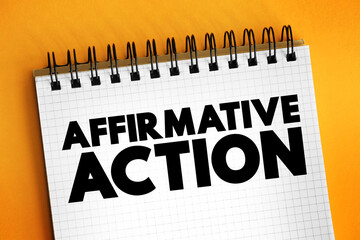 Affirmative action - set of policies and practices within a government or organization seeking to include particular groups, text concept on notepad
