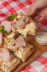 tasty cream-based pizza with ham and mushrooms