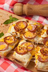 pizza with cream sauce with smoked sausage and cheddar sauce
