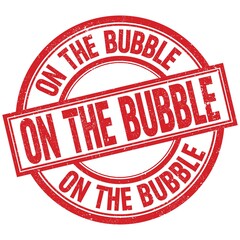 ON THE BUBBLE written word on red stamp sign