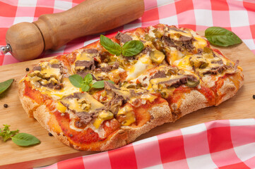pizza with beef gherkins and jalapeno, mozzarella cheese and cheddar sauce