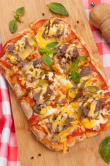 pizza with beef gherkins and jalapeno, mozzarella cheese and cheddar sauce