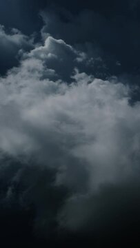 Lot of lightning during a thunderstorm. Storm clouds are moving fast on the viewer. Vertical video