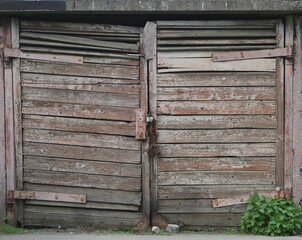 Closed old wooden gate with peeling paint