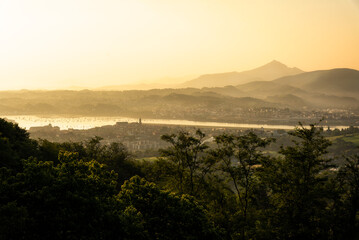 Top panoramic view of the village of Hondarribia with the French village of Hendaye in the background at a foggy sunrise, Gipuzkoa, Basque Country, Spain