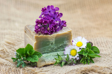 Obraz na płótnie Canvas bar of natural soap, herbs and flowers