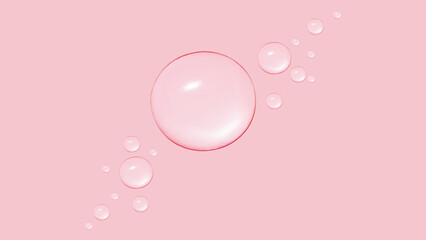 Drops of transparent gel or water in different sizes. On a pink background.