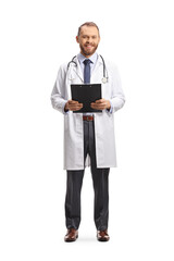 Full length portrait of a male physician smiling and holding a clipboard