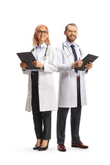 Male and female doctors standing and holding clipboards