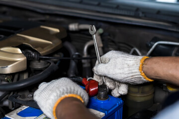 Close up car mechanic hands using tool fixing car in auto repair shop, Car Maintenance