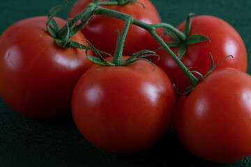 A group of grape tomatoes on a green background,closeup