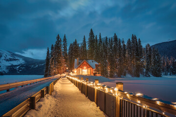 Emerald Lake with wooden lodge glowing in snowy pine forest on winter at Yoho national park