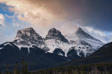 Naklejka na ściany i meble Sunrise over Three sisters mountains in Banff national park at Canmore