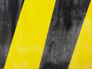 dirty textured striped surface of black and yellow wall warning sign background