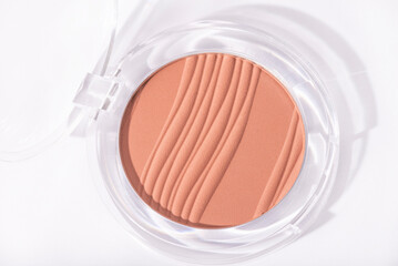 Face powder makeup products isolated on white background with shadows