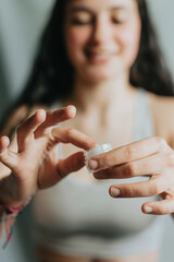 Close-up of hands testing a lotion cream in a tube, young woman taking care of her skin. Spa, sunscreen and model thinking of a cosmetics product for dermatology and facial wellness.
