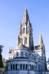 The tall Gothic spire of an Anglican church in Cork, Ireland. Neo-Gothic Christian religious architecture. Cathedral Church of St Fin Barre, Cork - One of Ireland’s Iconic Buildings.