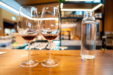 wine glass filled with two red wines for tourists to taste red wine in a vineyard restaurant