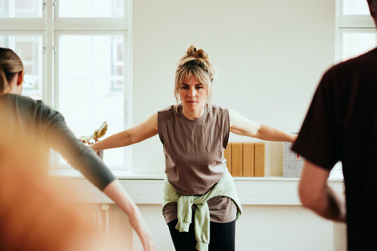 Female teacher leading a yoga class