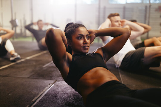 Fit woman working her core during a gym exercise class