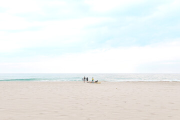 Fototapeta na wymiar Surfers walking to the sea to surf