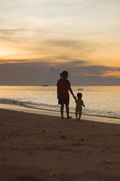 parent and child at sunset