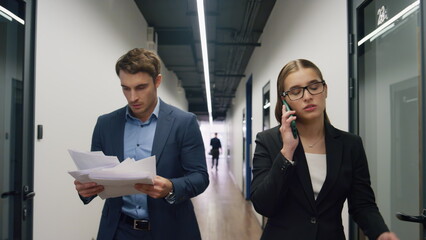 Upset manager share bad news on call. Concerned executive check contract papers