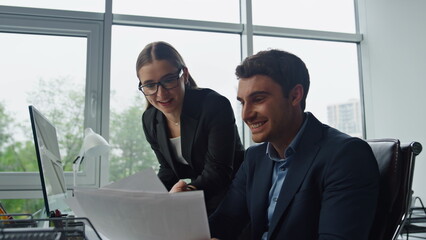 Managers team check report profitable results closeup. Happy workers celebrate