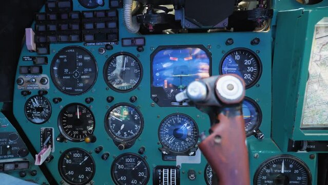 Inside the cockpit of the Mi-24 military transport helicopter. A close-up view of the control panel, instruments, sensors and steering wheel. Russian military helicopter