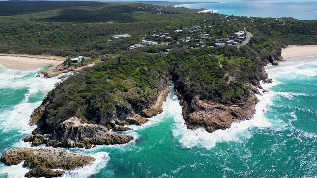 Still Aerial Shot of Rocky Cliffs Surrounded by Blue Crashing Waves, Stradbroke Island, Point Lookout, North Gorge