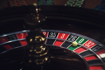 Casino roulette, close-up of a roulette ball, sectors red and black zero