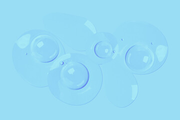 round drops of transparent gel serum on a blue background. gel with bubbles. Water droplets