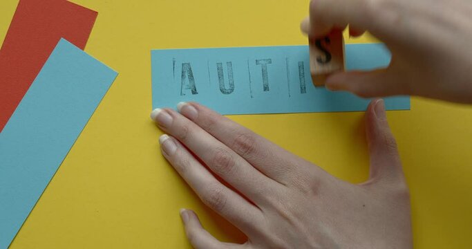 Autism therapy words written with rubber stamps on a paper. Autism Spectrum Disorder treatment concept.