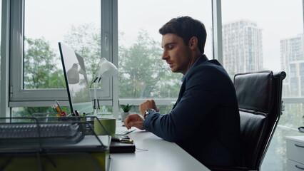 Sales manager making call in contemporary office. Smiling businessman talking