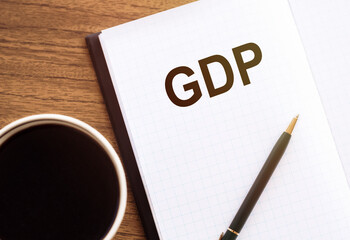 GDP - Text on a notepad with coffee and pan, business concept