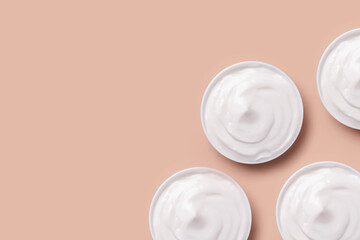 set of jars of cream in white on a beige background.