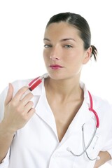 Doctor woman with red syringe and needle in her lips over white background
