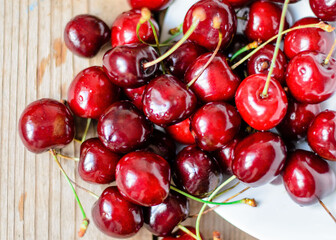 Juicy sweet cherry on old wooden background