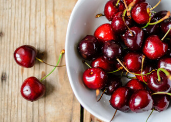 Juicy sweet cherry on old wooden background