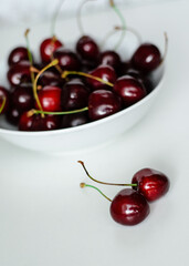 Juicy cherries on a white plate, close-up