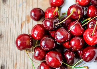 Juicy sweet cherry on old wooden background