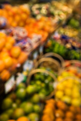 Blurred fruit stacks at grocery store.