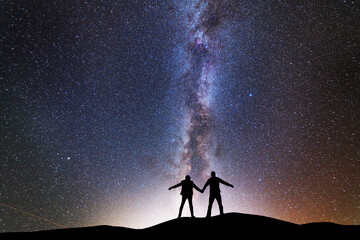 Fototapeta premium Fantasy landscape, silhouette of losers standing on the hill, on the milky way galaxy background.