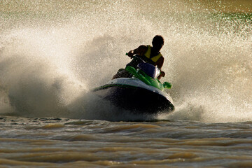 Backlit jet ski with water spray