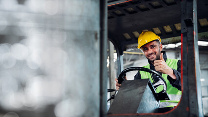 Industrial worker driving a forklift in the factory. Engineer is working and maintaining in the...
