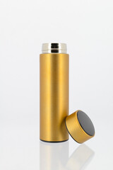 Gold vaccum flask on white background.