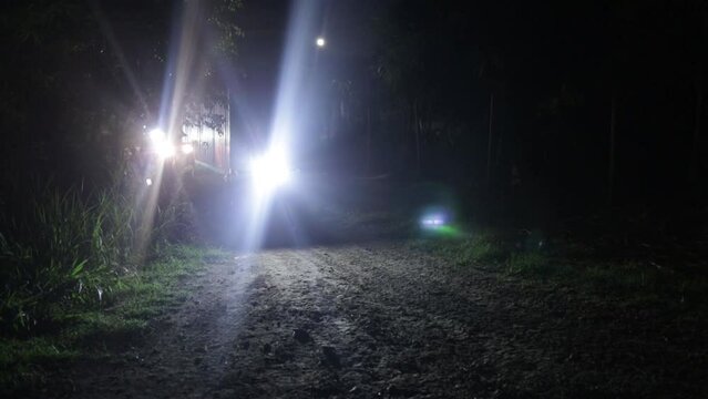 People riding quad bike through a field, atv motorbike, at night